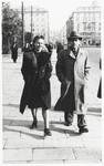 A young Jewish couple from Poland walks along a street in Pisa, Italy.
