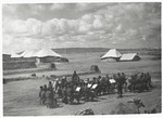 Members of the orchestra of the 2nd Polish Corps (Anders Army) perform outside at their military base in the Iraqi desert, where they were stationed from the summer of 1942 until the summer of 1943.
