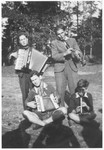 Four friends play music together in the yard of the Montintin children's home.