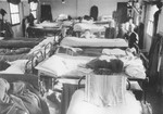 View of the interior of a crowded barracks in the Kitchener refugee camp in Richborough (Kent), England.