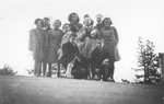 OSE workers pose with a group of children in Font-Romeu, a summer camp site, where they were brought after being smuggled out of the Rivesaltes internment camp.
