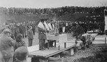 Three men draped in tallitot lead prayers at the dedication of a memorial at the site of the Pocking concentration camp.