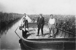 Prisoners pose on a barge that is in a canal that they are digging in the Staphorst-Rouveen labor camp.