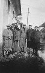 A group of boys stands on a street corner n Nowy Targ.