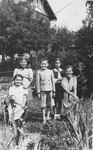 Serafina Strasser poses in a garden with her sister Pola and a group of friends.