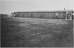 View of a barracks in the Bergen-Belsen concentration camp decorated with a wall size portrait of Adolf Hitler, shortly before it was burned down to prevent the spread of infection.