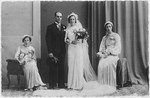 Wedding portrait of Daniel and Clara Frances flanked by two bridesmaids.