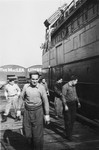 A crew member of the President Warfield (later the Exodus 1947) walks along the pier next to the ship

Pictured is Eli Kalm, chief steward of the ship.