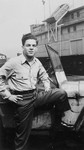Arthur Lifshitz (later Avi Livni), a crew member of the President Warfield (later The Exodus 1947) poses near the ship in Baltimore harbor.