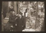 Harry Fiedler with a bookseller/fortune-teller on Tongshan Road in Hongkew.