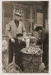 Jewish refugees Harry Fiedler and Heim Leiter pose next to a potato vendor on a Shanghai street.