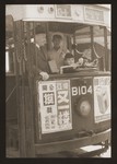 Harry Fiedler sits in the driver's seat of a Shanghai streetcar.