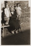 A Jewish refugee woman poses with two young children in Shanghai.