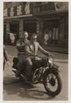 Eric Goldstaub rides a motorcycle with a friend on the streets of Shanghai.