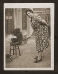 Else Blumenthal, the donor's aunt, fans a charcoal stove in front of her living quarters in Shanghai.