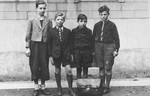 Group portrait of four Jewish boys who are being sheltered by Father Bruno.