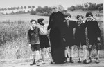 Father Bruno poses with five Jewish children he is sheltering.