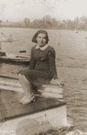 Rochelle Szklarski sits by a lake or river near the Bad Reichenhall displaced persons camp.
