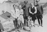 Basia Israel poses with her mother, two Jewish policemen and another couple in the Krakow ghetto.