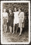 Four young Jewish women pose outside at the Eschwege displaced persons camp.