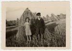 Two Jewish children pose in front of a haystack.

Pictured are Ruth and Herbert Karliner.