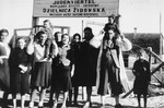 A group of Jews pose in front of the entrance to the Wisznice ghetto.