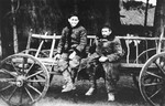 A father and son sit on a wagon in the Wisznice ghetto.