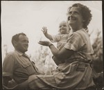 Haika Grosman relaxes with her husband, Meir Orkin, and daughter, Leah, on Kibbutz Evron.