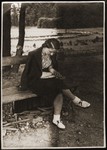 Haika Grosman reads on a park bench in Brest, where she had been sent by the Hashomer Hatzair Zionist youth movement to organize their regional activities.