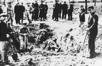 Laborers exhume the corpses of people shot during an action on 12 May 1942.