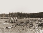 American soldiers view the corpses of slave laborers shot by the SS in the vicinity of Hirzenhain.
