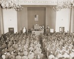 Pfc. Alfred Monheit of the Bronx, NY. receits Kol Nidre at Yom Kippur services held for GI's in Berlin, conducted by chaplain Isadore Breslau, Washington D.C.