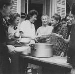 OSE relief worker Margot Stein serves soup to a group of Jewish refugee women at the Hotel Bompard internment camp.