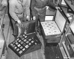 American soldiers open cases of jewels and snuff boxes looted from the home of Maurice Rothschild in Paris and brought to Germany.