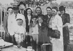 Mordechai Chaim Rumkowski, chairman of the Lodz ghetto Jewish Council and Zygmunt Reingold, head of food supply, pose with family members in the ghetto.