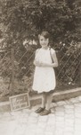 Edith Loeb poses next to a slate that reads "My first day of school."
