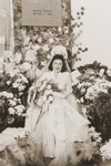 A Jewish DP bride sits on a throne surrounded by flowers in Fuerth, Germany.