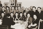Group portrait of members of the Betar Zionist youth movement gathered around a table in Fuerth, Germany.