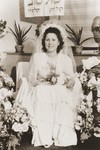 A Jewish DP bride sits on a throne surrounded by flowers in Fuerth, Germany.