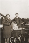 An Austrian Jewish family in Vienna in 1939.  Willy Spiegler poses with his wife, Kathe, and young child, who is sitting in a baby carriage.