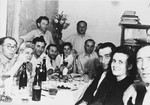 Jewish displaced persons gather around a table for a celebration in the Lampertheim DP camp.
