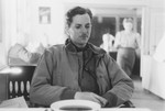 Portrait of U.S. combat photographer Arnold E. Samuelson seated in a dining hall with a bowl of soup.