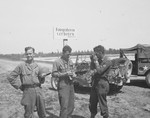 Three U.S. combat photographers from the 167th Signal Photo Company stop to take pictures in front of a German sign that reads, "Photography is prohibited."

Pictured on the left is Walt MacDonald.