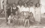 Artur and Luise Koenigstein pose with their children in a cabana on the beach during their summer vacation.