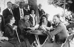 Members of the Gruenwald family play cards outside at a vacation resort in Croatia.