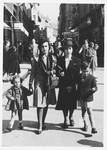 A Jewish family walks along a commercial street in Sarajevo.