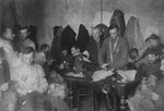 Jewish men working in a sewing workshop in the Glubokoye ghetto.