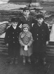 Four Jewish cousins pose in a family-owned lumberyard in Kazimierza Wielka.