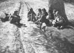 Jewish refugees rest beneath a tree during their escape over the Alps to Italy from the Italian-occupied zone in France following the signing of the Italian armistice.