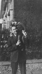 Manfred Grunbaum holds his daughter, Dorien, on his shoulder shortly after their return to Holland.